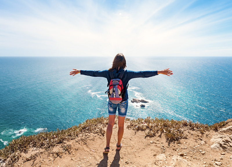 Girl tourist at the westernmost point of Europe, Cabo da Roca, Portugal