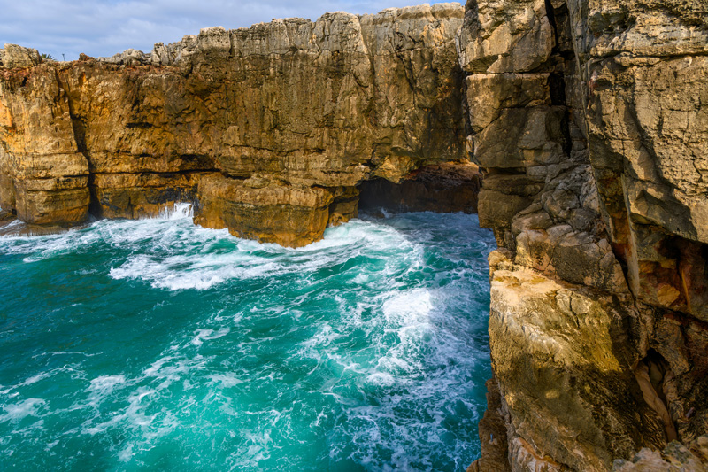 Boca do Inferno, or the mouth of Hell is a chasm located in the seaside cliffs close to the city of Cascais, Portugal, in the District of Lisbon, where seawater rushes in and out of a rocky opening.